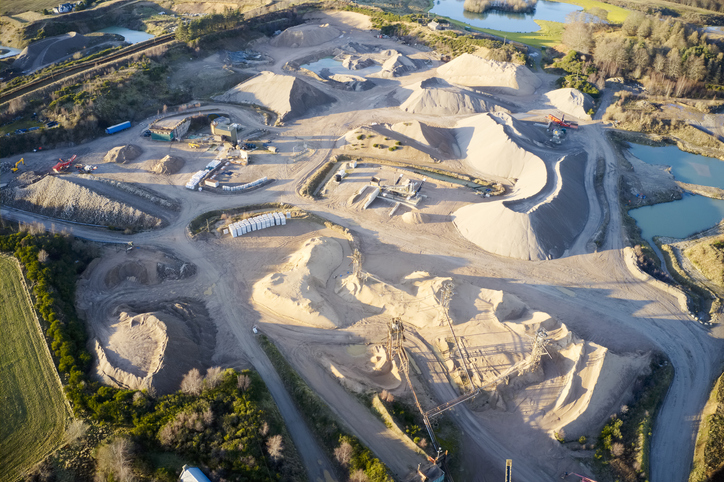 Quarry works industrial digging aerial view from above showing sand mound and hills food ingredients recruitment